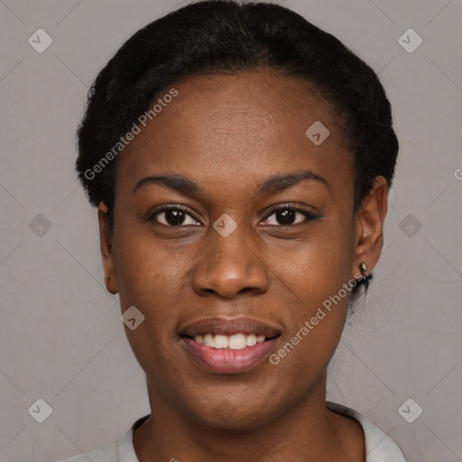 Joyful black young-adult female with short  black hair and brown eyes