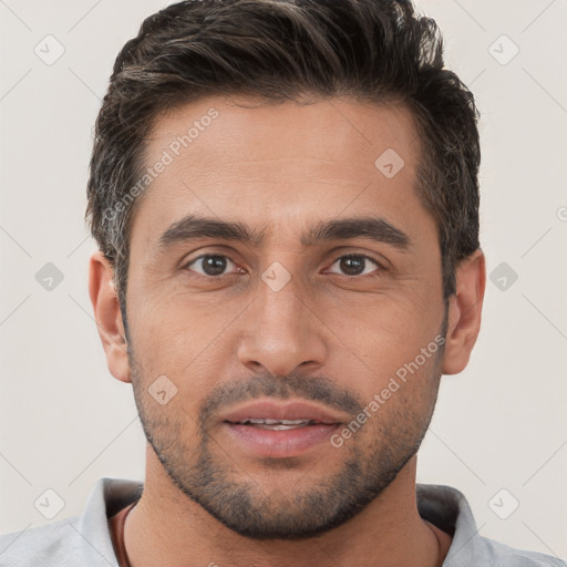 Joyful white young-adult male with short  brown hair and brown eyes