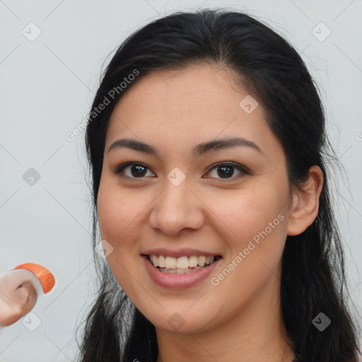 Joyful white young-adult female with long  brown hair and brown eyes