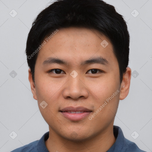 Joyful asian young-adult male with short  black hair and brown eyes