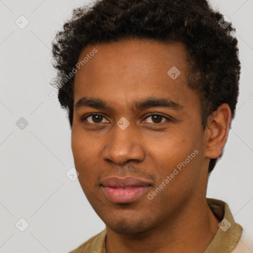 Joyful black young-adult male with short  brown hair and brown eyes