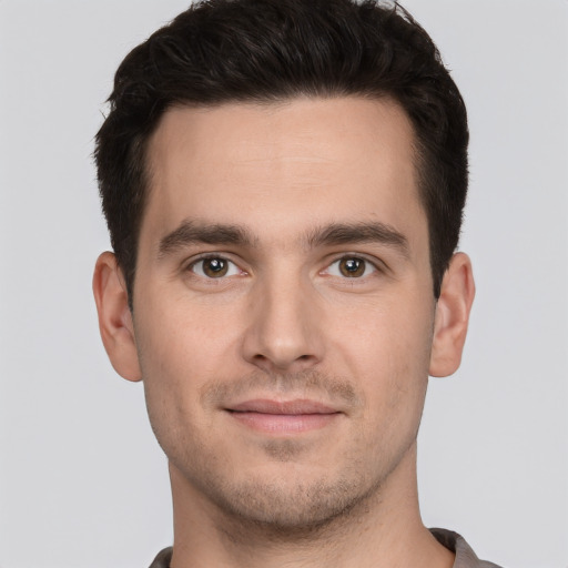 Joyful white young-adult male with short  brown hair and brown eyes