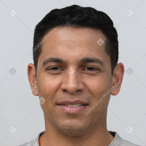 Joyful white young-adult male with short  black hair and brown eyes