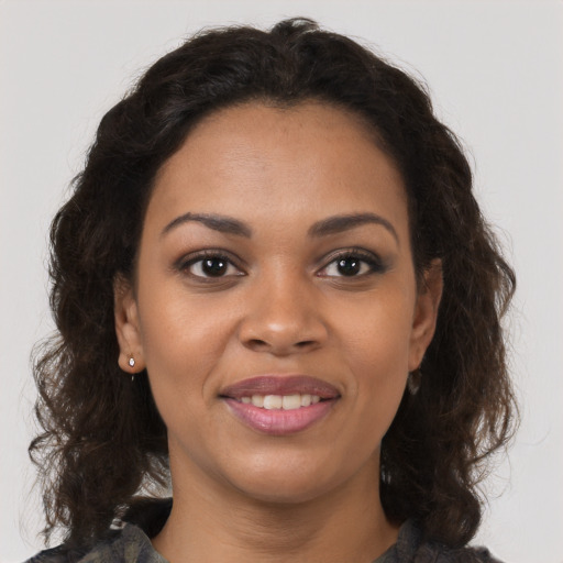 Joyful black young-adult female with medium  brown hair and brown eyes