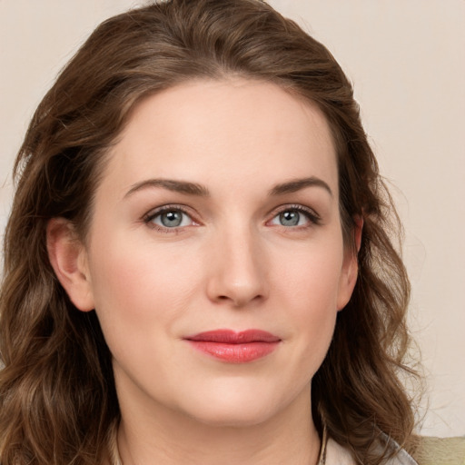 Joyful white young-adult female with long  brown hair and grey eyes