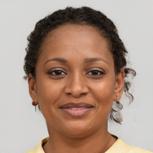 Joyful black adult female with short  brown hair and brown eyes