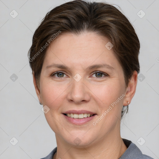 Joyful white adult female with short  brown hair and grey eyes