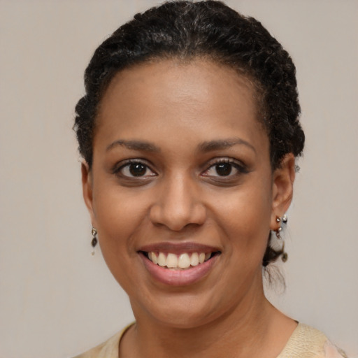 Joyful black young-adult female with short  brown hair and brown eyes