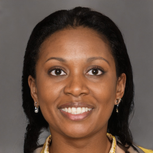 Joyful black young-adult female with long  black hair and brown eyes