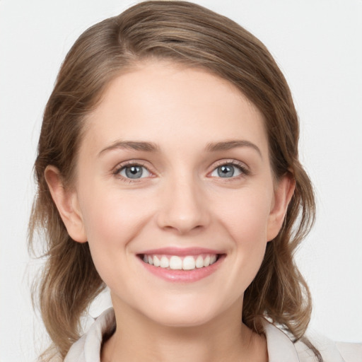 Joyful white young-adult female with medium  brown hair and blue eyes