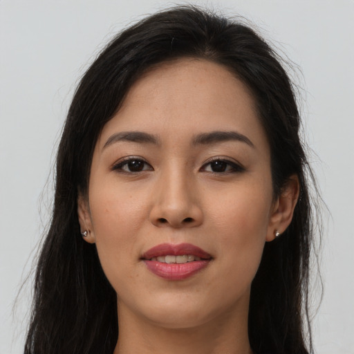 Joyful asian young-adult female with long  brown hair and brown eyes