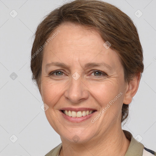 Joyful white adult female with medium  brown hair and grey eyes