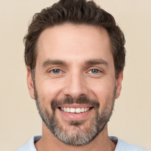 Joyful white adult male with short  brown hair and brown eyes