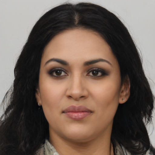 Joyful latino young-adult female with long  black hair and brown eyes