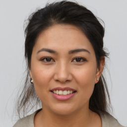 Joyful asian young-adult female with medium  brown hair and brown eyes