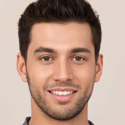 Joyful white young-adult male with short  brown hair and brown eyes