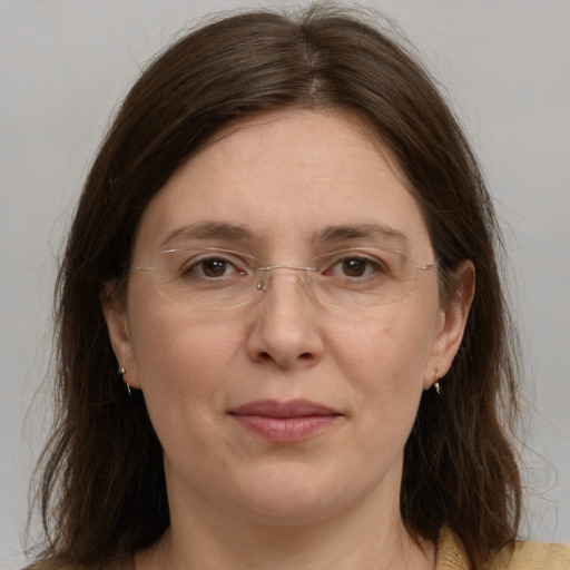 Joyful white adult female with medium  brown hair and grey eyes