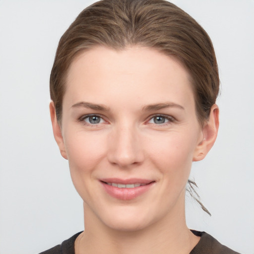 Joyful white young-adult female with short  brown hair and grey eyes