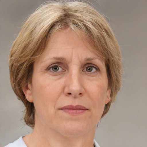 Joyful white adult female with medium  brown hair and grey eyes