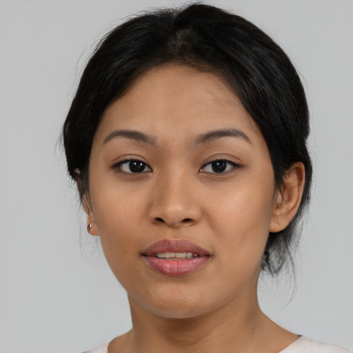 Joyful asian young-adult female with medium  black hair and brown eyes
