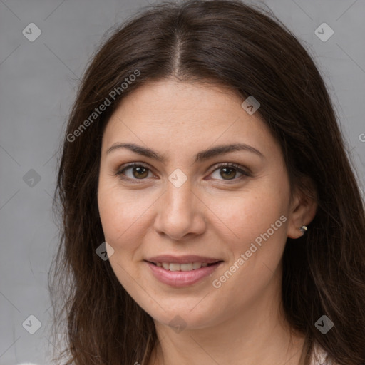 Joyful white young-adult female with long  brown hair and brown eyes