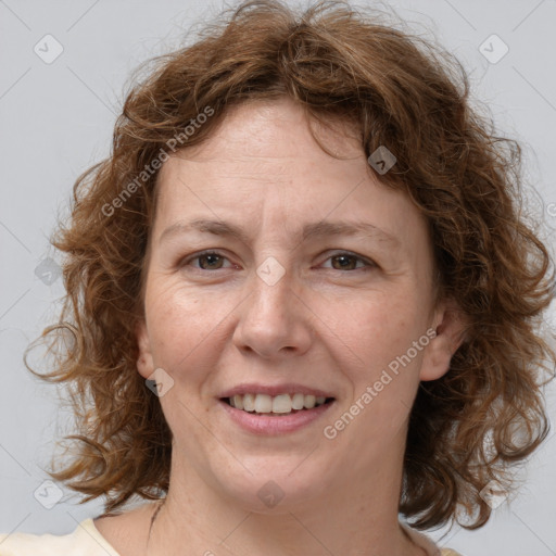 Joyful white adult female with medium  brown hair and green eyes