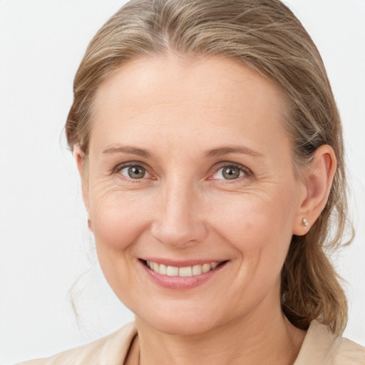 Joyful white adult female with medium  brown hair and grey eyes