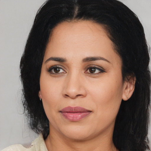 Joyful latino young-adult female with medium  black hair and brown eyes
