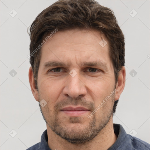 Joyful white adult male with short  brown hair and grey eyes