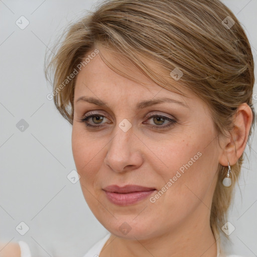 Joyful white adult female with medium  brown hair and blue eyes