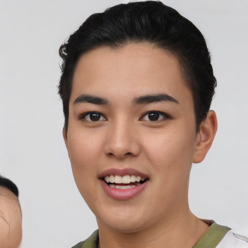 Joyful asian young-adult female with short  black hair and brown eyes