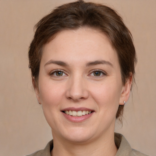 Joyful white young-adult female with short  brown hair and brown eyes