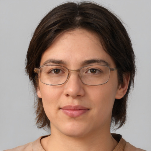 Joyful white adult female with medium  brown hair and brown eyes