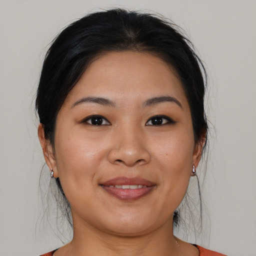 Joyful asian young-adult female with medium  brown hair and brown eyes