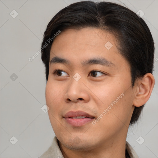 Joyful asian young-adult male with short  brown hair and brown eyes