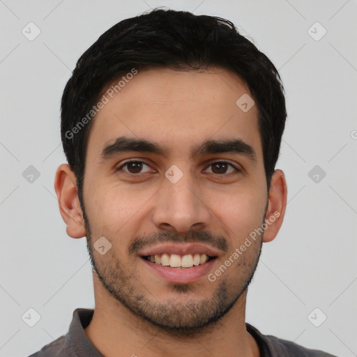 Joyful latino young-adult male with short  black hair and brown eyes