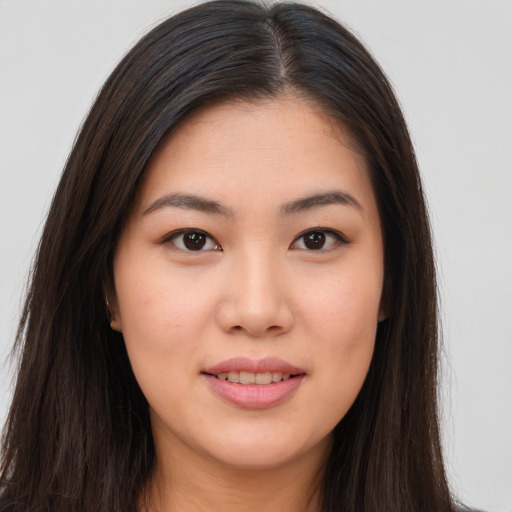 Joyful asian young-adult female with long  brown hair and brown eyes