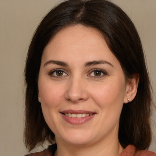 Joyful white young-adult female with medium  brown hair and brown eyes