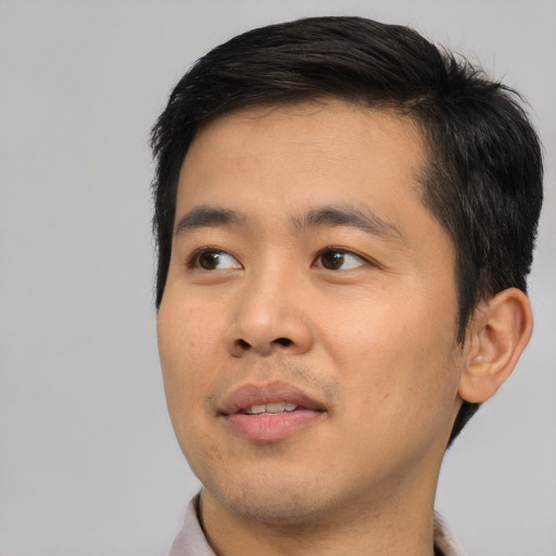Joyful asian young-adult male with short  black hair and brown eyes