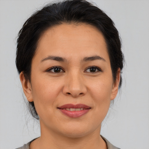 Joyful asian young-adult female with medium  brown hair and brown eyes