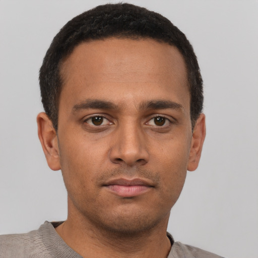Neutral latino young-adult male with short  brown hair and brown eyes