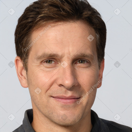 Joyful white adult male with short  brown hair and grey eyes