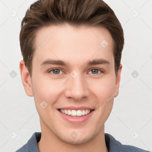 Joyful white young-adult male with short  brown hair and grey eyes