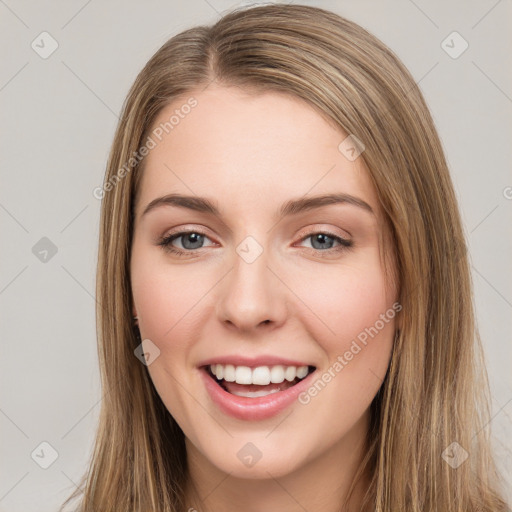 Joyful white young-adult female with long  brown hair and green eyes