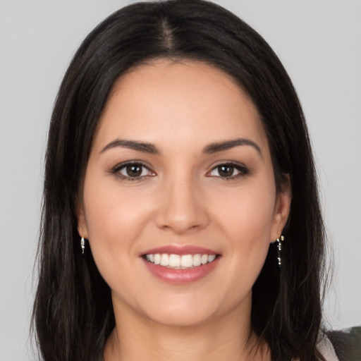 Joyful white young-adult female with long  brown hair and brown eyes