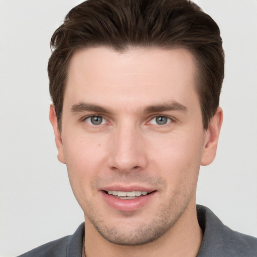 Joyful white young-adult male with short  brown hair and brown eyes