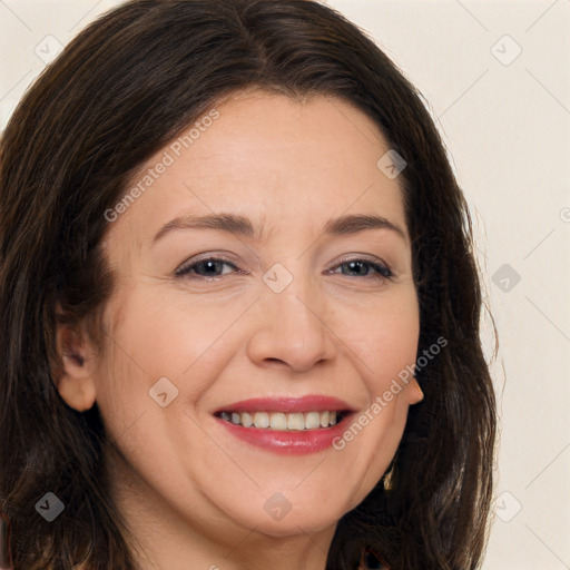 Joyful white adult female with long  brown hair and brown eyes