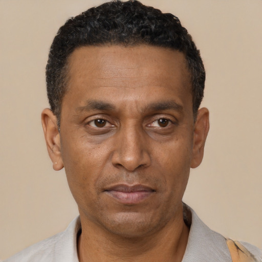 Neutral black adult male with short  black hair and brown eyes