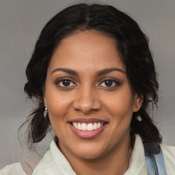 Joyful black young-adult female with medium  brown hair and brown eyes