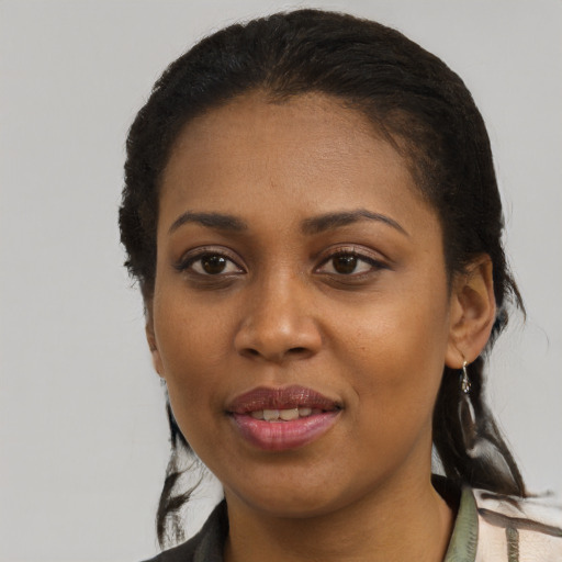 Joyful black young-adult female with medium  black hair and brown eyes